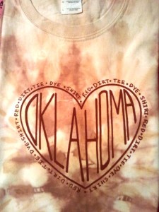 How lovely is this? Your heart is where your home is, Oklahoma! Made with genuine red clay and dye this shirt is sure to be a fashionable OK T!